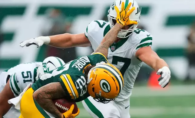 Green Bay Packers wide receiver Skyy Moore (23) put his hand in the face of New York Jets fullback Andrew Beck (47) face during an NFL football game in East Rutherford, N.J., Sunday, Sept. 20, 2026. (AP Photo/Yuki Iwamura)