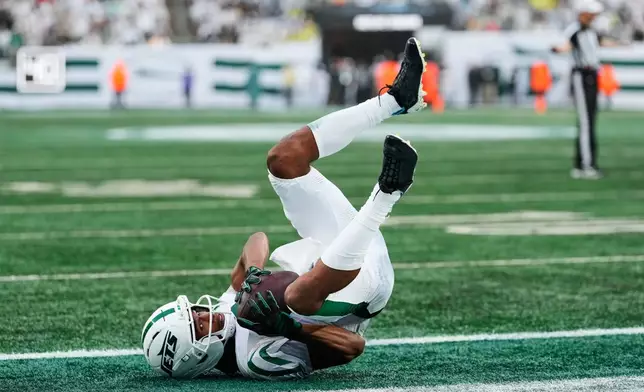 New York Jets wide receiver Garrett Wilson (5) falls into the end zone during an NFL football game against the Green Bay Packers in East Rutherford, N.J., Sunday, Sept. 20, 2026. (AP Photo/Yuki Iwamura)