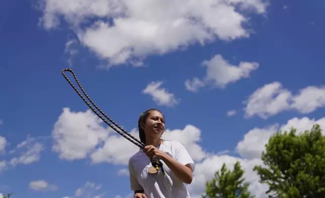 A guest practices rope meditation at Organic Compound's annual event, "Halfway to Harmony," in Faribault, Minn., Saturday, June 20, 2026. (AP Photo/Jessie Wardarski)