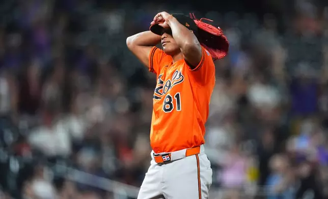 Baltimore Orioles relief pitcher Luis De Leon reacts after giving up a two-run home run to Colorado Rockies' TJ Rumfield in the seventh inning of a baseball game Tuesday, Sept. 1, 2026, in Denver. (AP Photo/David Zalubowski)