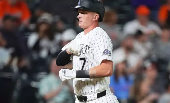 Colorado Rockies' TJ Rumfield gestures as he crosses home plate after hitting a two-run home run off Baltimore Orioles relief pitcher Luis De Leon in the seventh inning of a baseball game Tuesday, Sept. 1, 2026, in Denver. (AP Photo/David Zalubowski)