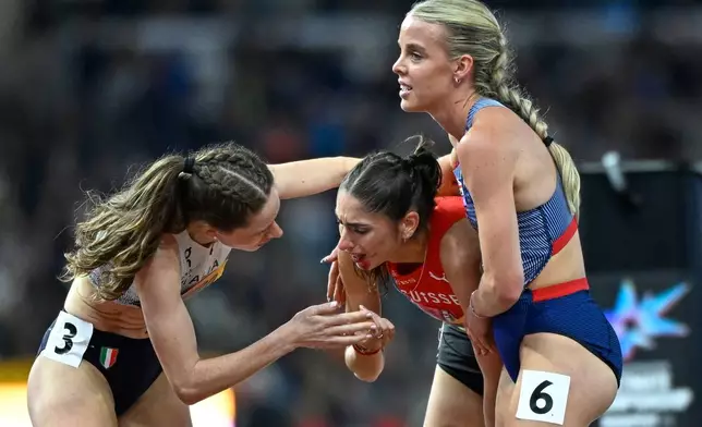 Keely Hodgkinson, of Britain, right, assists Veronica Vancardo, of Switzerland, who fell in a women's 800 meters semifinal during the World Athletics Ultimate Championship in Budapest, Hungary, Friday, Sept. 11, 2026. (AP Photo/Denes Erdos)