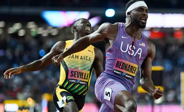 Kenneth Bednarek, of the United States beats Oblique Seville, of Jamaica to win the men's 100 meters final during the World Athletics Ultimate Championship in Budapest, Hungary, Saturday, Sept. 12, 2026. (AP Photo/Denes Erdos)