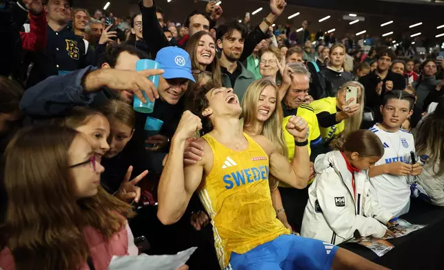 Armand Duplantis, of Sweden, celebrates with the audience after winning the men's pole vault final during the World Athletics Ultimate Championship in Budapest, Hungary, Friday, Sept. 11, 2026. (AP Photo/Armin Durgut)