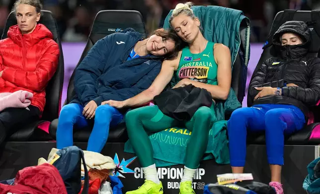 Angelina Topic, of Serbia, center left, and Eleanor Patterson, of Australia, wait their turn to make an attempt in the women's high jump final at the World Athletics Ultimate Championship in Budapest, Hungary, Friday, Sept. 11, 2026. (AP Photo/Matthias Schrader)