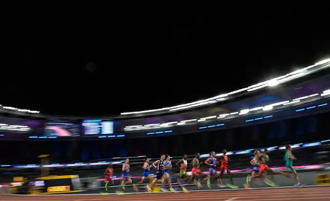 Jakob Ingebrigtsen, of Norway, center, races before winning the men's 5,000 meters final during the World Athletics Ultimate Championship in Budapest, Hungary, Friday, Sept. 11, 2026. (AP Photo/Denes Erdos)