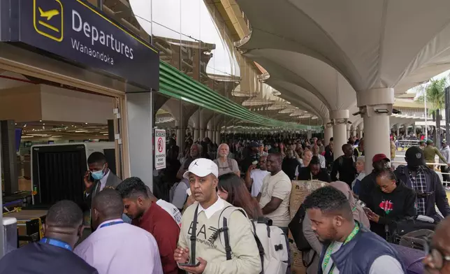 Passengers queue at the departure area during a workers strike at Jomo Kenyatta International Airport in Nairobi, Kenya, Monday, Aug. 31, 2026. (AP Photo/Brian Inganga)