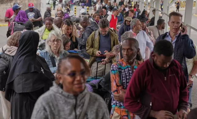 Passengers queue at the departure area during a workers strike at Jomo Kenyatta International Airport in Nairobi, Kenya, Monday, Aug. 31, 2026. (AP Photo/Brian Inganga)