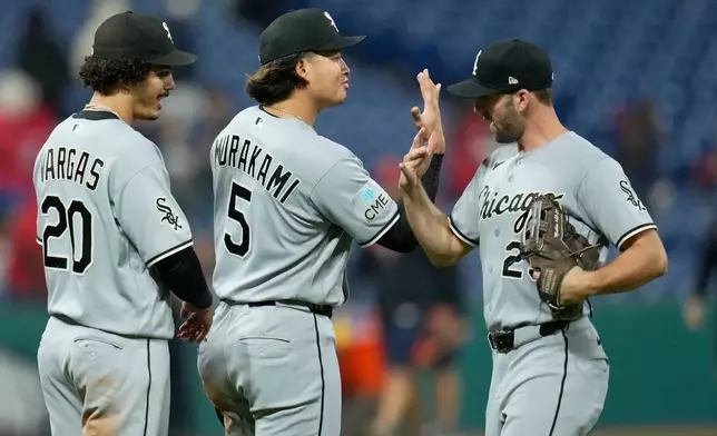 Chicago White Sox's Miguel Vargas (20), Munetaka Murakami (5) and Tristan Peters, right, celebrate after the White Sox defeated the Cleveland Guardians in a baseball game in Cleveland, Monday, Sept. 14, 2026. (AP Photo/Sue Ogrocki)