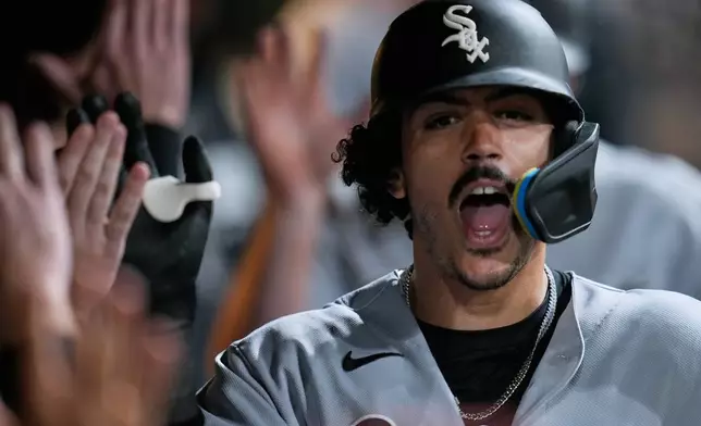 Chicago White Sox's Miguel Vargas celebrates in the dugout after hitting a home run in the sixth inning of a baseball game against the Cleveland Guardians in Cleveland, Monday, Sept. 14, 2026. (AP Photo/Sue Ogrocki)