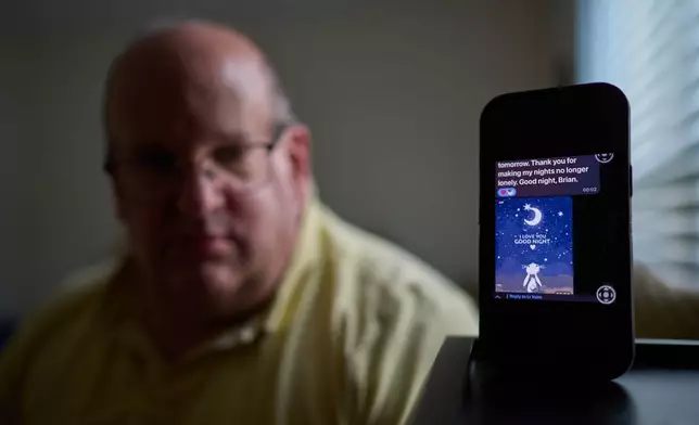 A text message from a scammer who stole $575,000 from Brian Glick is displayed on Glick's phone as he poses for a portrait at his home, Wednesday, June 25, 2025, in Ballston Lake, N.Y. (AP Photo/David Goldman)