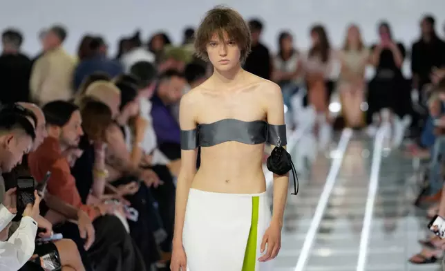A model wears a creation part of the Prada women's Spring-Summer 2027 collection presented in Milan, Italy, Tuesday, Sept. 22, 2026. (AP Photo/Luca Bruno).