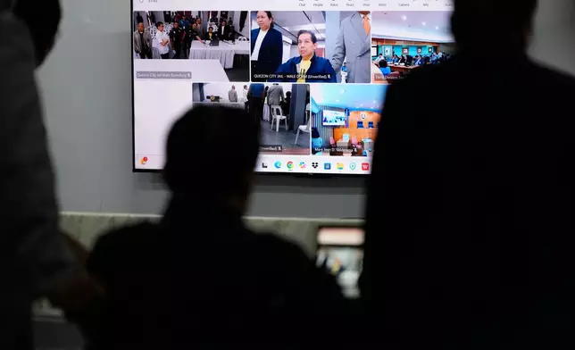 Philippines former House Speaker Martin Romualdez, center, a cousin of President Ferdinand Marcos Jr., watches the screen as he waits for the start of his arraignment via video conference at the Quezon City Jail in Quezon, Philippines, Wednesday, Sept. 16, 2026. (AP Photo/Aaron Favila, Pool)