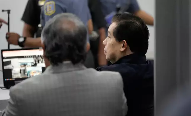 Philippines former House Speaker Martin Romualdez, right, a cousin of President Ferdinand Marcos Jr., waits for the start of his arraignment via video conference at the Quezon City Jail in Quezon, Philippines, Wednesday, Sept. 16, 2026. (AP Photo/Aaron Favila, Pool)