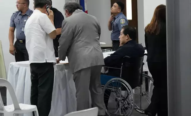 Philippines former House Speaker Martin Romualdez, second right, a cousin of President Ferdinand Marcos Jr., waits for the start of his arraignment via video conference at the Quezon City Jail in Quezon, Philippines, Wednesday, Sept. 16, 2026. (AP Photo/Aaron Favila, Pool)