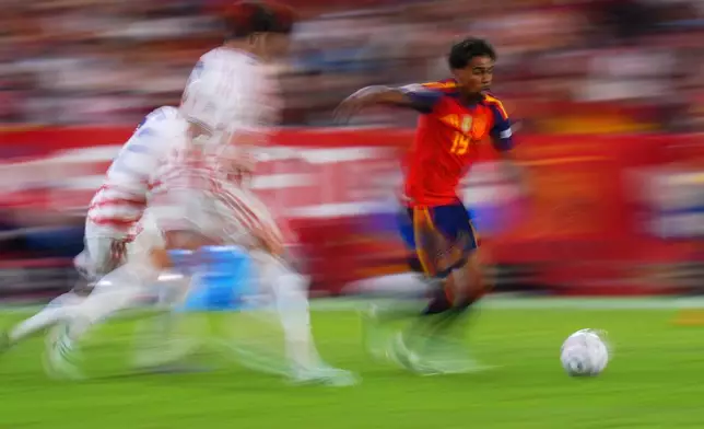 In this photo taken with slow shutter speed Spain's Lamine Yamal is in action during the Nations League soccer match between Spain and Croatia in Seville, Spain, Tuesday, Sept. 29, 2026. (AP Photo/Manu Fernandez)