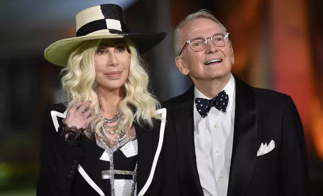 FILE - Cher, left, and designer Bob Mackie arrive at the Academy Museum of Motion Pictures Gala on Sept. 25, 2021, in Los Angeles. (Photo by Richard Shotwell/Invision/AP, File)