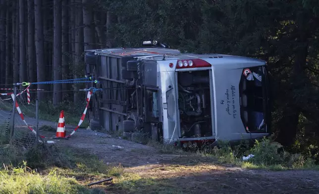 A view of the scene after a tourist bus veered off a highway, in Buchloe, Germany, Sunday, Sept. 27, 2026. (Karl-Josef Hildenbrand/dpa via AP)