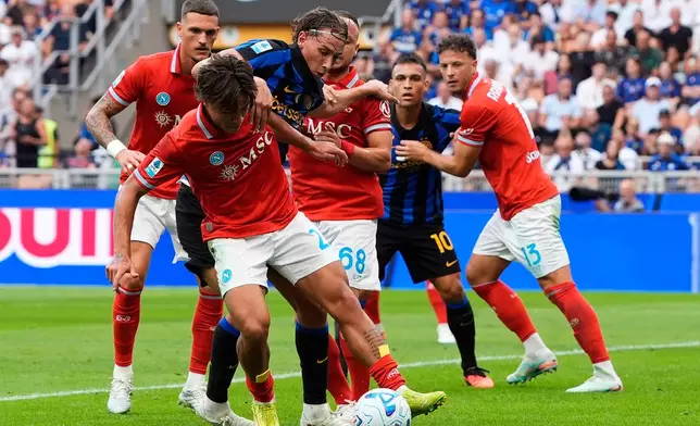 Inter's Pio Esposito fights for the ball with Napoli's Rafa Marin, Napoli's Antonio Vergara, Napoli's Stanislav Lobotka during the Serie A soccer match between Inter and Napoli at the San Siro Stadium in Milan, Italy, Saturday, Sept. 5, 2026. (Fabio Ferrari/LaPresse via AP)
