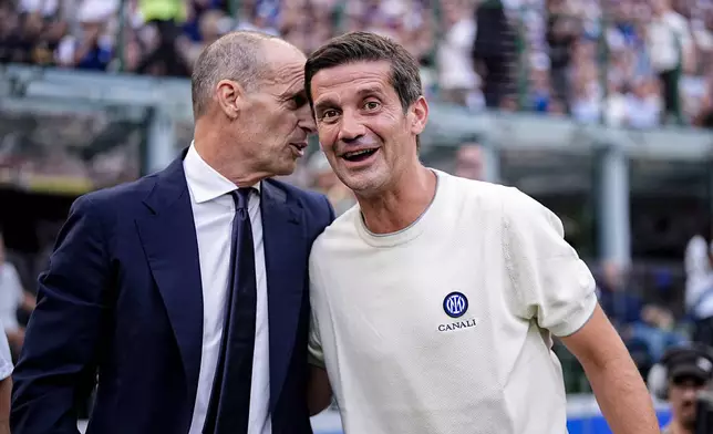 Napoli's head coach Massimiliano Allegri and Inter's head coach Cristian Chivu, right, talk during the Serie A soccer match between Inter and Napoli at the San Siro Stadium in Milan, Italy, Saturday, Sept. 5, 2026. (Marco Alpozzi/LaPresse via AP)