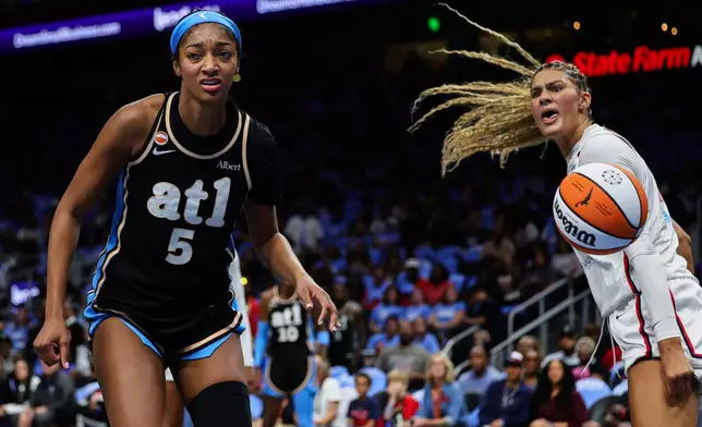 Atlanta Dream forward Angel Reese (5) and Washington Mystics center Lauren Betts, right, react during the first half in Game 1 of an WNBA basketball first-round playoff series, Sunday, Sept. 27, 2026, in Atlanta. (AP Photo/Colin Hubbard)
