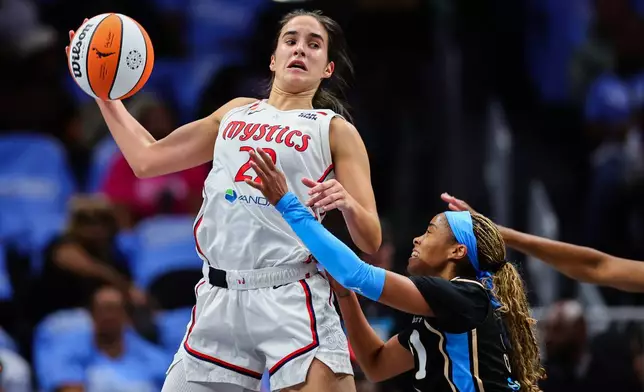 Washington Mystics guard Sonia Citron, left, looks to pass against Atlanta Dream guard Jordin Canada, right, during the first half in Game 1 of an WNBA basketball first-round playoff series, Sunday, Sept. 27, 2026, in Atlanta. (AP Photo/Colin Hubbard)