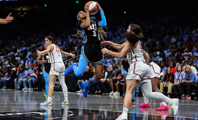 Atlanta Dream guard Jordin Canada (3) goes up to shoot against Washington Mystics guard Georgia Amoore, right, during the first half in Game 1 of an WNBA basketball first-round playoff series, Sunday, Sept. 27, 2026, in Atlanta. (AP Photo/Colin Hubbard)