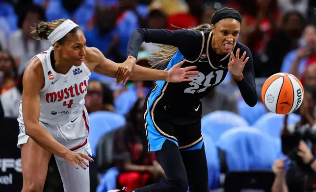 Washington Mystics guard Betnijah Laney-Hamilton, left, fights for the ball with Atlanta Dream forward DeWanna Bonner, right, during the first half in Game 1 of an WNBA basketball first-round playoff series, Sunday, Sept. 27, 2026, in Atlanta. (AP Photo/Colin Hubbard)
