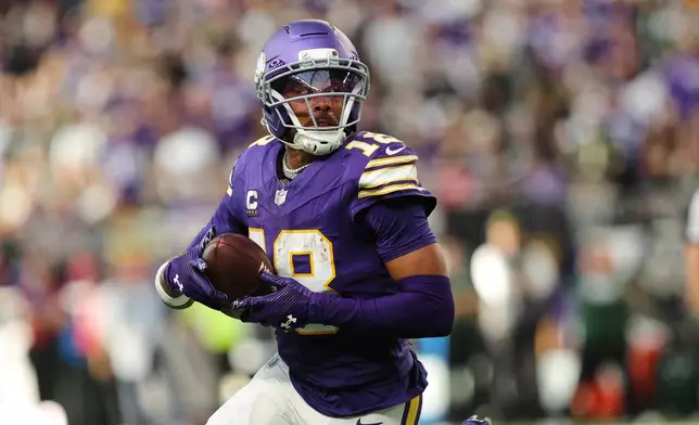 Minnesota Vikings wide receiver Justin Jefferson gains yards after a catch during the second half of an NFL football game against the Green Bay Packers, Sunday, Sept. 13, 2026, in Minneapolis, Minn. (AP Photo/Bailey Hillesheim)