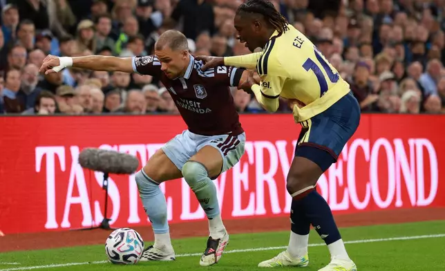 Aston Villa's Matty Cash, left, and Arsenal's Eberechi Eze challenge for the ball during the English Premier League soccer match between Aston Villa and Arsenal in Birmingham, England, Monday, Aug. 31, 2026. (AP Photo/Morgan Harlow)