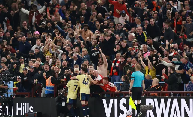 Arsenal's Bukayo Saka (7) celebrates with team mate Arsenal's Declan Rice after scoring his side's opening goal during the English Premier League soccer match between Aston Villa and Arsenal in Birmingham, England, Monday, Aug. 31, 2026. (AP Photo/Morgan Harlow)