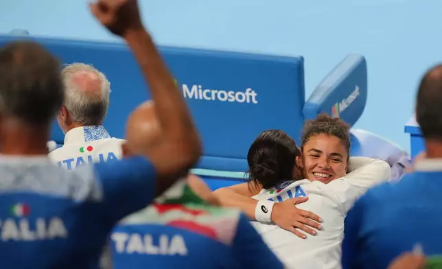 Italy's Jasmine Paolini hugs a member of her team after winning the Billie Jean King Cup women doubles quarterfinals tennis match between China and Italy, in Shenzhen, China's Guangdong province, Friday, Sept. 25, 2026. (AP Photo/Andy Wong)