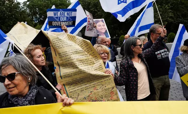 Demonstrators wave Israeli flags during a protest ahead of Israeli Prime Minister Benjamin Netanyahu's address at the 81st session of the United Nations General Assembly, Thursday, Sept. 24, 2026, in New York. (AP Photo/Madison Swart)