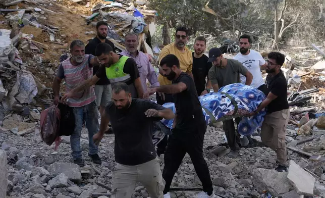 People carry a body of a person who was killed at a house that was hit by an Israeli airstrike in Arab Salim village, southern Lebanon, Sunday, Sept. 6, 2026. (AP Photo/Mohammed Zaatari) CORRECTION: Corrects village name to Arab Salim instead of Araba Salim