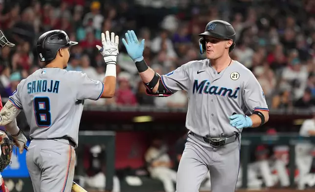 Miami Marlins' Griffin Conine, right, celebrates his home run against the Arizona Diamondbacks with Marlins' Javier Sanoja (8) during the fourth inning of a baseball game, Tuesday, Sept. 15, 2026, in Phoenix. (AP Photo/Ross D. Franklin)