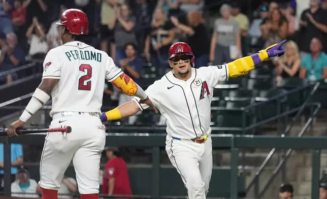 Arizona Diamondbacks' Gabriel Moreno, right, celebrates his home run against the Miami Marlins with Diamondbacks' Geraldo Perdomo (2) during the first inning of a baseball game, Tuesday, Sept. 15, 2026, in Phoenix. (AP Photo/Ross D. Franklin)