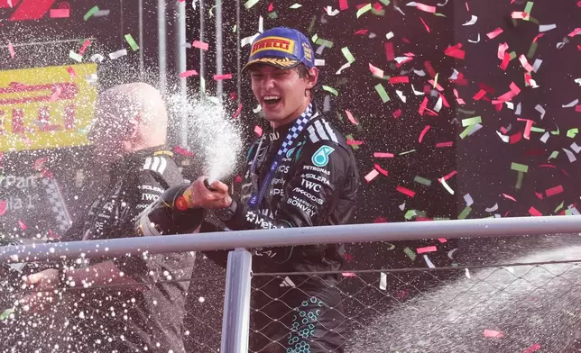 Mercedes driver Andrea Kimi Antonelli of Italy celebrates on the podium after winning the Italian Formula One Grand Prix race, in Monza, Italy, Sunday, Sept. 6, 2026. (AP Photo/Antonio Calanni)