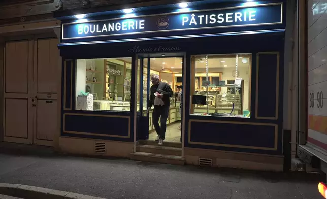 A customer leaves the bakery of Kevin Luce in Saint-Just-en-Chaussee, France, Thursday Sept. 24, 2026. (AP Photo/John Leicester)