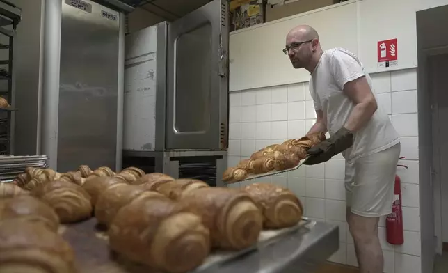 Baker Kevin Luce makes pastries in Saint-Just-en-Chaussee, France, Thursday Sept. 24, 2026. (AP Photo/John Leicester)