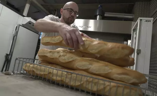 Baker Kevin Luce makes bread in Saint-Just-en-Chaussee, France, Thursday Sept. 24, 2026. (AP Photo/John Leicester)
