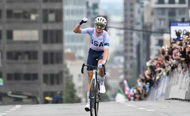 Brandon McNulty, of the United States, celebrates winning the men's elite road race at the UCI Road World Championships cycling event in Montreal, Sunday, Sept. 27, 2026. (Graham Hughes/The Canadian Press via AP)