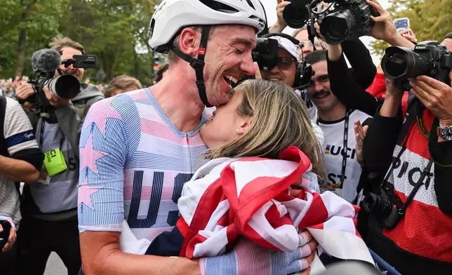 Brandon McNulty, of the United States, is hugged by his wife Summer after winning the men's elite road race at the UCI Road World Championships cycling event in Montreal on Sunday, Sept. 27, 2026. (Graham Hughes/The Canadian Press via AP)