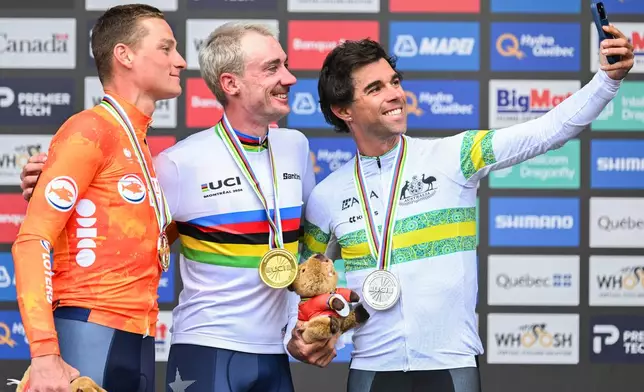 Brandon McNulty, of the United States, centre, Michael Matthews, of Australia, right, and Mathieu van der Poel, of the Netherlands, pose for a selfie following the men's elite road race at the UCI Road World Championships cycling event in Montreal on Sunday, Sept. 27, 2026. (Graham Hughes/The Canadian Press via AP)