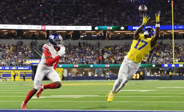 Los Angeles Rams wide receiver Davante Adams (17) makes a touchdown catch past New York Giants cornerback Colton Hood (12) during the second half of an NFL football game in Inglewood, Calif., Monday, Sept. 21, 2026. (AP Photo/Katie Chin)