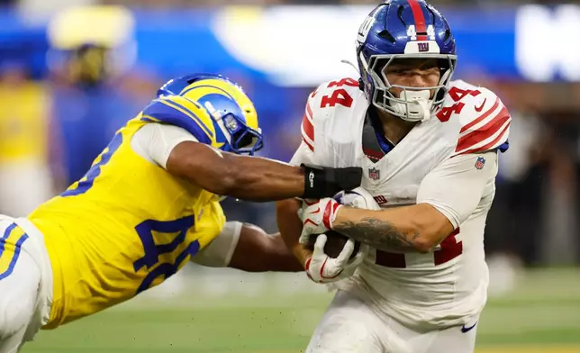 New York Giants running back Cam Skattebo (44) is tackled by Los Angeles Rams linebacker Omar Speights (48) during the first half of an NFL football game in Inglewood, Calif., Monday, Sept. 21, 2026. (AP Photo/Caroline Brehman)