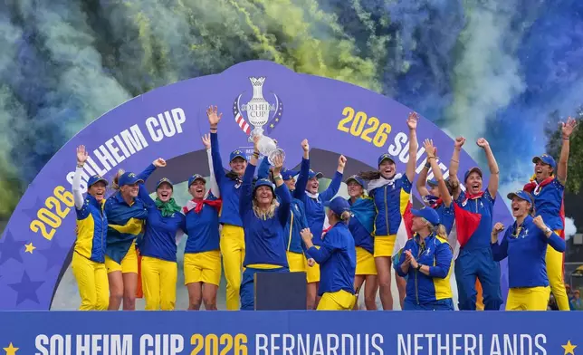 Anna Nordqvist, Europe team captain, holds the trophy aloft after her team won the Solheim Cup in Den Bosch, Netherlands, Sunday, Sept. 13, 2026. (AP Photo/Alastair Grant)
