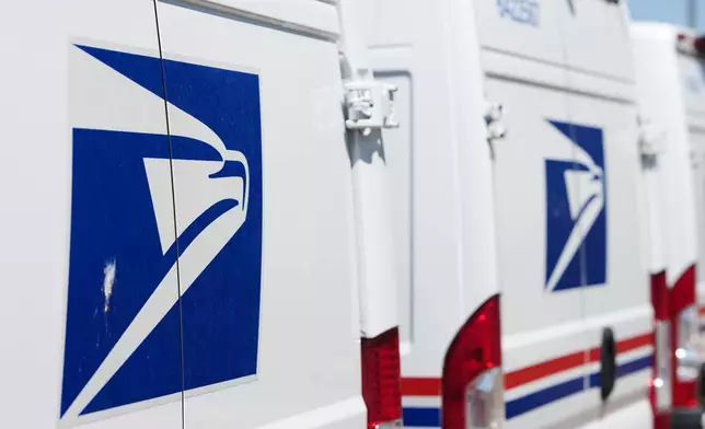 FILE - Delivery vans are parked during a protest staged as part of a countrywide National Day of Action Tuesday, July 28, 2026, outside the main United States Postal Service headquarters in northeast Denver. (AP Photo/David Zalubowski, File)