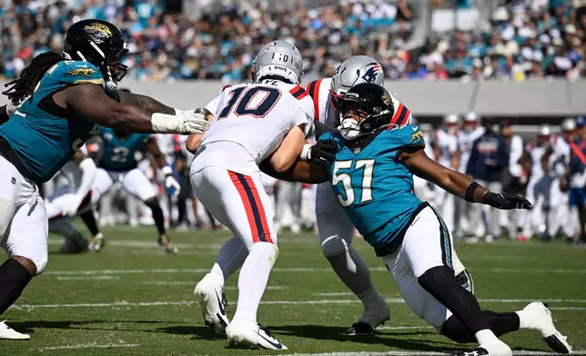 Jacksonville Jaguars defensive end Bryan Thomas Jr. (57) sacks New England Patriots quarterback Drake Maye (10) in the second half during an NFL football game in Jacksonville, Fla., Sunday, Sept. 27, 2026. (AP Photo/Phelan M. Ebenhack)