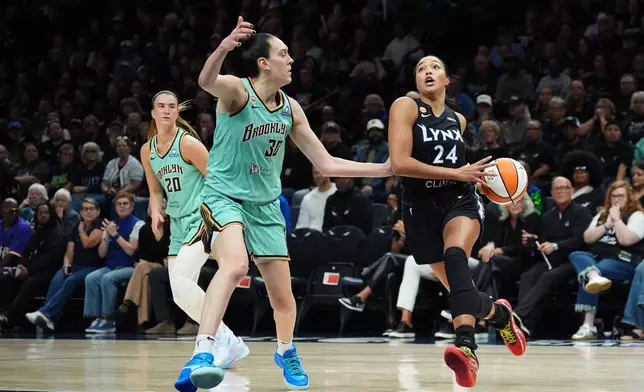 Minnesota Lynx forward Napheesa Collier (24) drives toward the hoop while New York Liberty forward Breanna Stewart (30) defends during the first half of Game 1 in the first round of the WNBA basketball playoffs, Sunday, Sept. 27, 2026, in Minneapolis. (AP Photo/Ellen Schmidt)