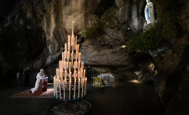 In this handout photo provided by Vatican Media Pope Leo XIV prays at the Grotto of the Apparitions of Massabielle, in Lourdes, France, Saturday, Sept. 26, 2026. (Vatican Media via AP)